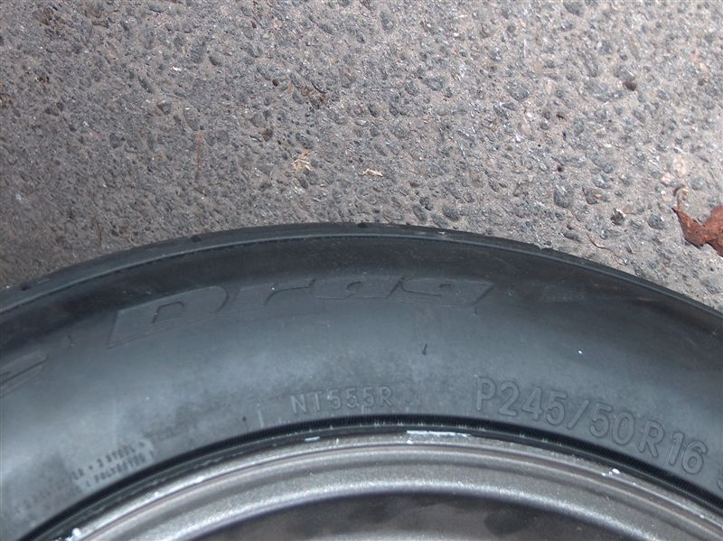 Tire with "Nitto NT555R P245/50R16" visible on the sidewall