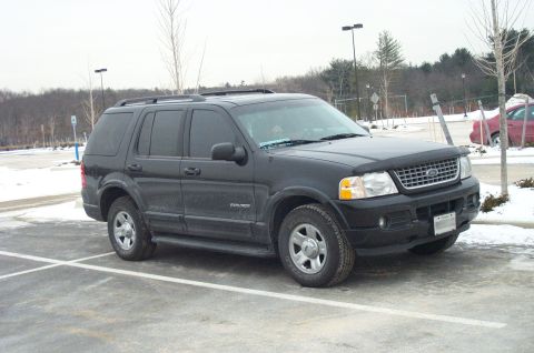 2001 Ford Crown Victoria - A black Ford Explorer is parked in a snowy lot, showing its front and side profile.