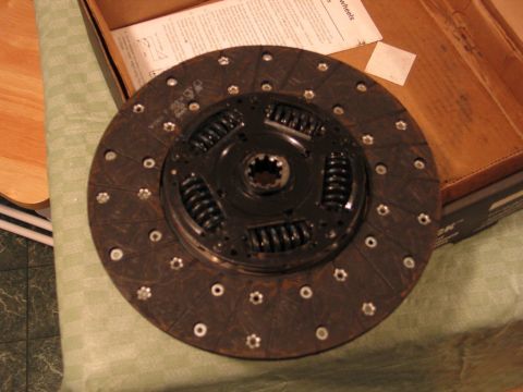 1989 Ford F-150 - A clutch disc is shown, part of a clutch replacement kit, with some text visible in the background.
