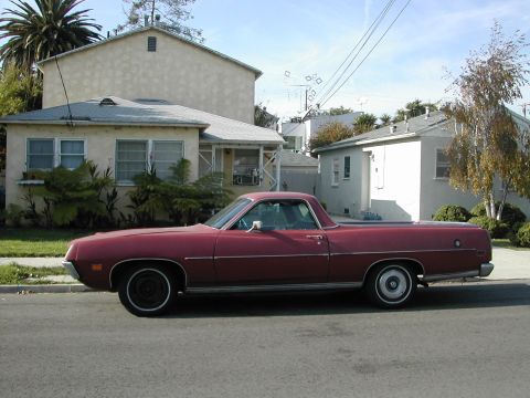 1973 Ford Ranchero - Side view of a maroon Ford Ranchero, likely a 1972 model, parked on a residential street.