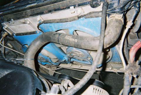 1996 Ford Bronco - Close-up view of the engine bay, focusing on the cooling system components and a blue structural element.