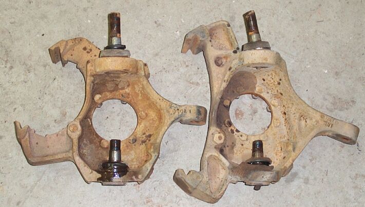 The knuckles won't swap because ball joint spacing is different by approx 1/2".  Note 8 lug knuckle uses 8 spindle studs; 5 lug knuckle uses 6 spindle studs