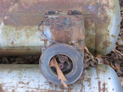 1989 Ford F-150 - This image shows a heavily rusted air compressor part, not a 1989 Ford F-150.
