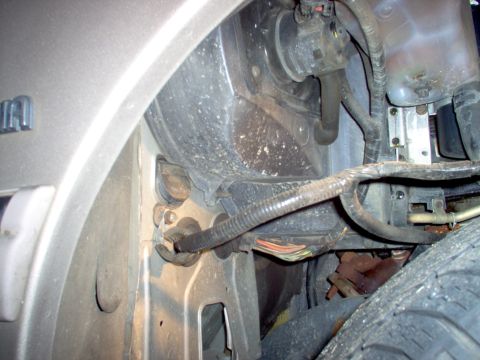 1994 Ford Crown Victoria - Close-up view of the engine bay of a 1994 Ford Crown Victoria, revealing various components and wiring.