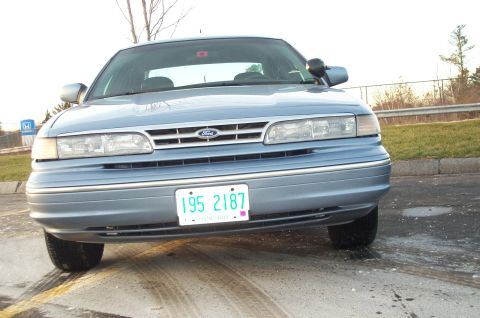 2001 Ford Crown Victoria - Front view of a light blue 2001 Ford Crown Victoria parked outdoors.