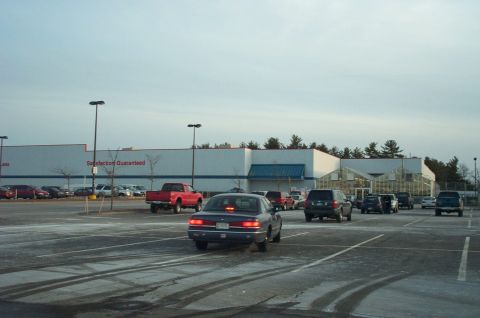2001 Ford Crown Victoria - A parking lot scene with multiple vehicles and a large store in the background.