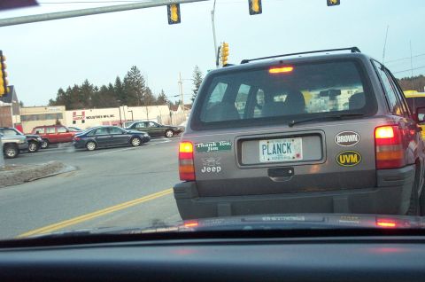 2001 Ford Crown Victoria - Jeep Grand Cherokee with custom license plate and stickers seen in traffic.