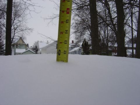 1998 Ford Taurus - Measuring snow depth with a ruler in a residential area during winter.