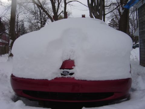 1998 Ford Taurus - A 1998 Ford Taurus is buried under a thick blanket of snow.