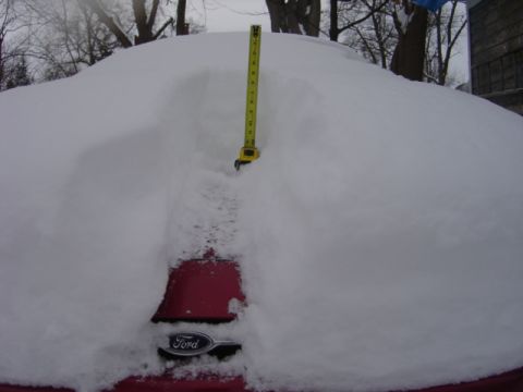 1998 Ford Taurus - Measuring snow depth on a vehicle after a heavy snowfall. A Ford emblem is visible.