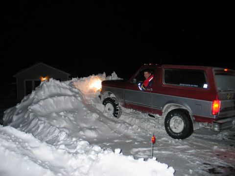 1995 Ford Bronco - Driver navigates a 1995 Ford Bronco through deep snow at night.