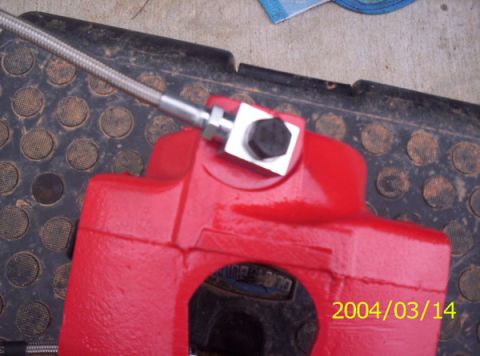 1986 Ford Bronco - Heres the lines attached to the caliper. Make sure not to overtighten the bolt. You don't want to strip those threads.