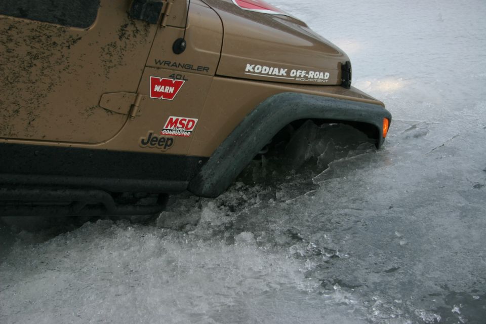 2003 Jeep TJ Wrangler stuck in ice, with KODIAK OFF-ROAD and WARN decals visible