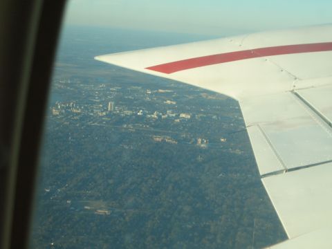 1988 Ford Bronco - Aerial view of a city seen from an airplane window, with the aircraft's wing visible in the foreground.