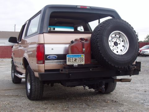 1994 Ford Bronco - Rear view of a 1994 Ford Bronco, equipped with a spare tire, auxiliary gas can, and aftermarket bumper.
