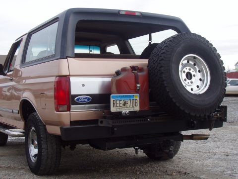 1994 Ford Bronco - Rear view of a 1994 Ford Bronco, equipped with a spare tire and a red gas can mounted on the bumper.