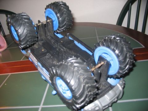 1978 Ford Bronco - A toy monster truck is shown upside down on a table.