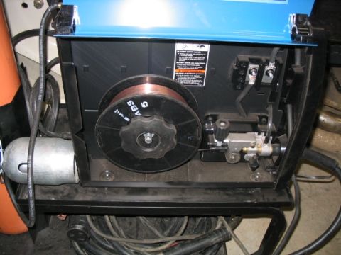 1986 Ford F-150 - Close-up view of the internal components of a welding machine, including a spool of welding wire.