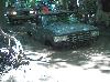 1995 Ford Bronco - Two vehicles navigate through a muddy, water-filled area, suggesting off-road conditions.
