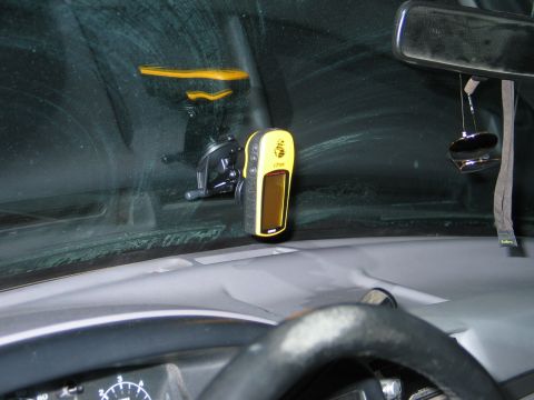 1995 Ford Bronco - GPS unit mounted on the interior windshield of a vehicle.