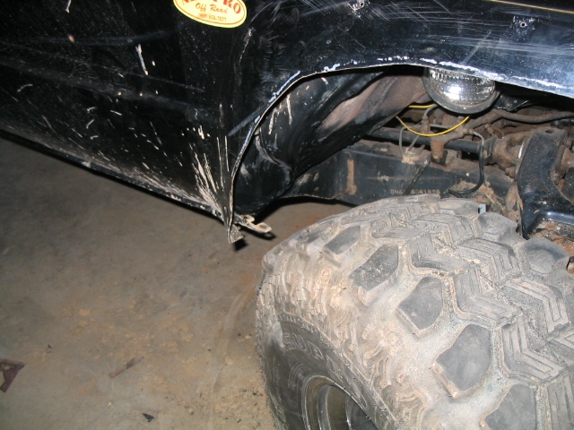 Black 1986 Ford F-150 fender and large off-road tire