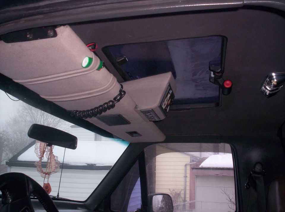 overhead console with radio and CB, sun visor with lights, sunroof, and rearview mirror