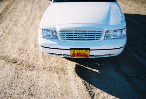 2000 Ford Crown Victoria - Front view of a white 2000 Ford Crown Victoria, displaying its grille and Nebraska license plate.