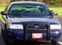 1998 Ford Crown Victoria - Front view of a dark blue Ford Crown Victoria, likely a police car, with a push bar.
