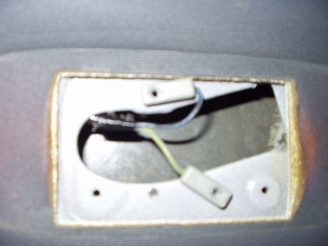 Dome light opening in gray headliner showing exposed wiring and connectors