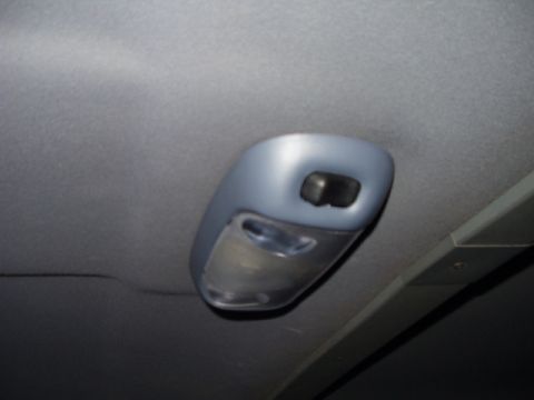 1993 Ford Bronco - Close-up of a vehicle's interior dome light assembly.