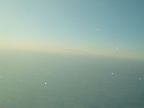 1988 Ford Bronco - Airplane window view of sky and clouds, with Supermotors.net watermark.