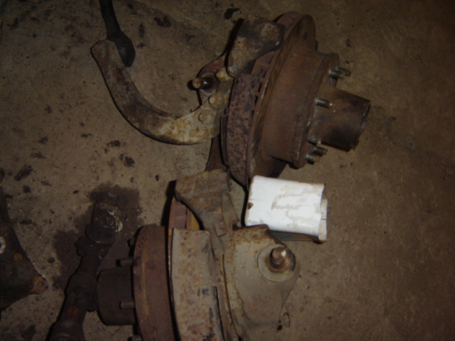rusty vehicle suspension components, including a brake rotor and hub assembly