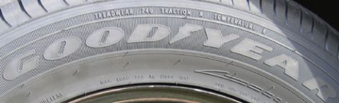 2000 Ford Crown Victoria - A detailed view of a tire's sidewall shows manufacturer information and specifications.