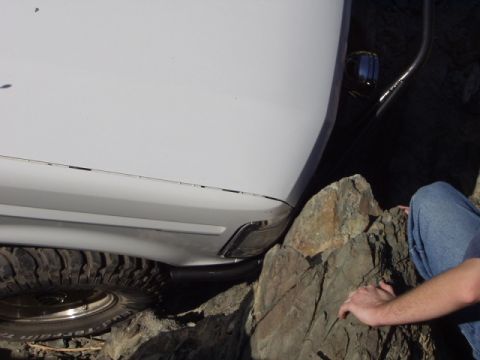 1993 Ford Bronco - White 1993 Ford Bronco navigating rocky terrain.