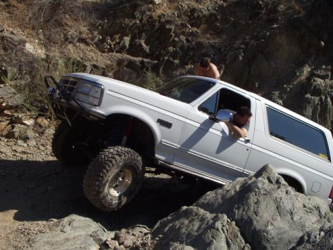 1993 Ford Bronco - This 1993 Ford Bronco is shown tackling a challenging off-road course with steep inclines and large rocks.