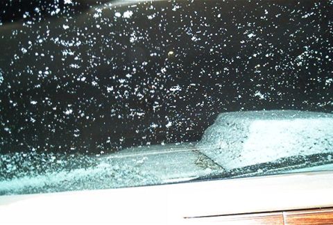 1985 Ford LTD Crown Victoria - Snowfall obscures the view through the windshield of a vehicle.