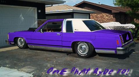 1985 Ford LTD Crown Victoria - A slammed purple two-door coupe with a white padded landau top and wire-spoke wheels, sitting low in a residential driveway. Blue text over…