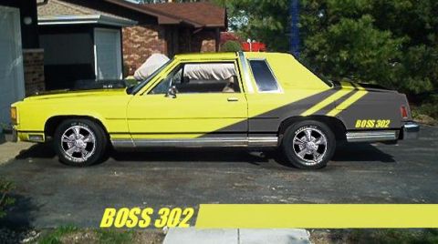 1985 Ford LTD Crown Victoria - Side profile of a yellow two-door Ford Crown Victoria coupe with black hockey-stick and wedge graphics and 'BOSS 302' lettering on the rear…