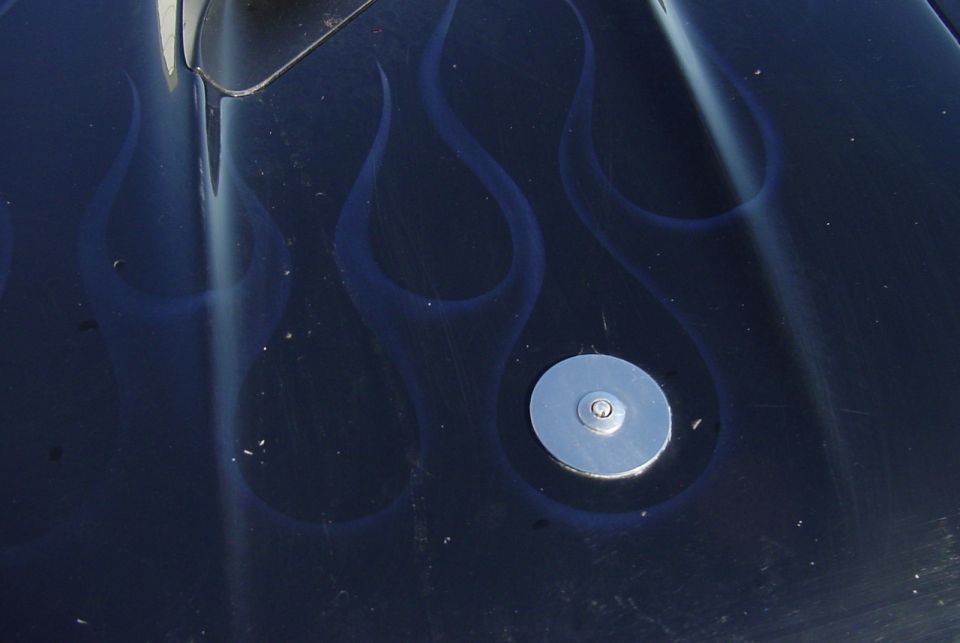 Dark blue body panel with ghost flames and a chrome flush-mount cap