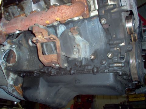 1994 Ford Crown Victoria - This is a close-up view of an engine block, showing the oil pan and exhaust manifold.