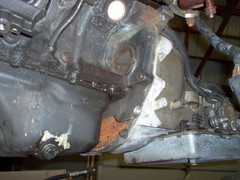 1994 Ford Crown Victoria - Close-up view of engine and transmission components, likely during removal or repair.