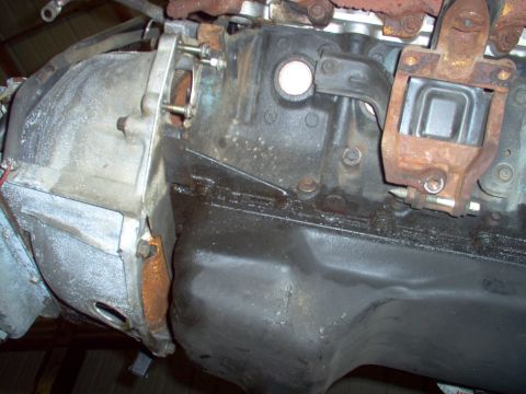 1994 Ford Crown Victoria - Close-up view of an engine block and transmission bell housing, with visible oil pan and mounting hardware.