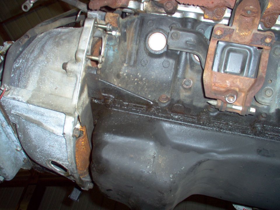 Engine block joined to bellhousing with rust and bolts