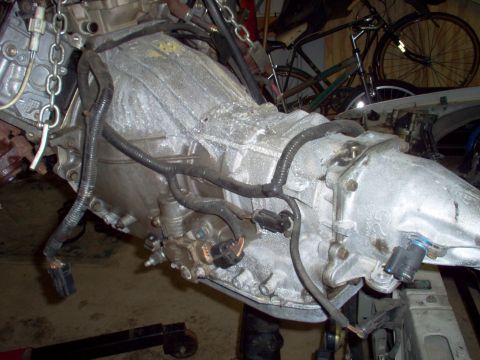 1994 Ford Crown Victoria - Engine and transmission assembly, likely removed from a vehicle, is shown with attached wiring.