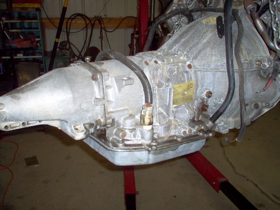 Removed automatic transmission on a red jack in a garage