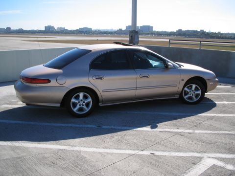 1997 Mercury Sable - Side view of a 1997 Mercury Sable sedan parked outdoors.