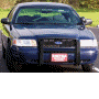 1998 Ford Crown Victoria - Front view of a dark blue police car, likely a Ford Crown Victoria, with a push bar installed.