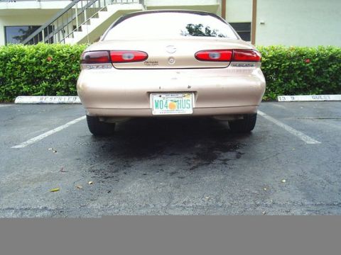 1997 Mercury Sable - The rear of a tan 1997 Mercury Sable is parked in a lot.