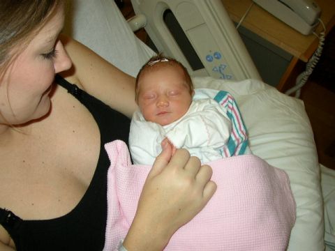 1995 Ford Bronco - A woman holds a newborn baby in a hospital setting.