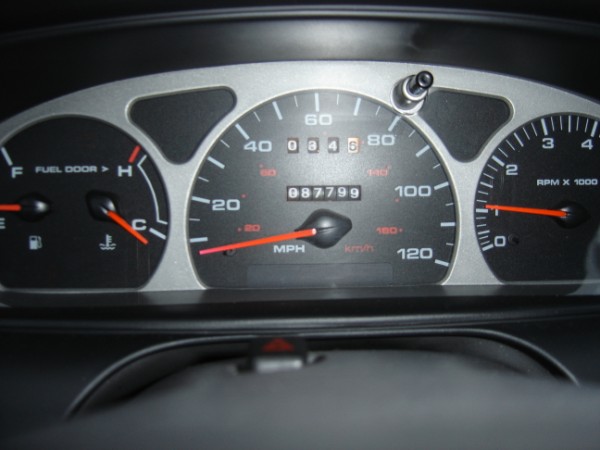 1999 Ford Taurus dashboard gauges with odometer reading 87799